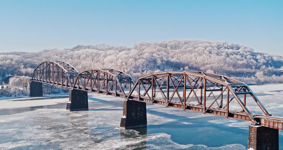 Water is frozen over under a long bridge