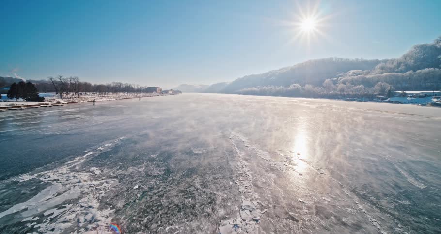 The sun shines down on a frozen lake
