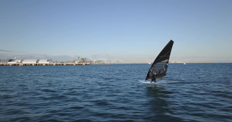 FPV drone chases a windsurfer across the water