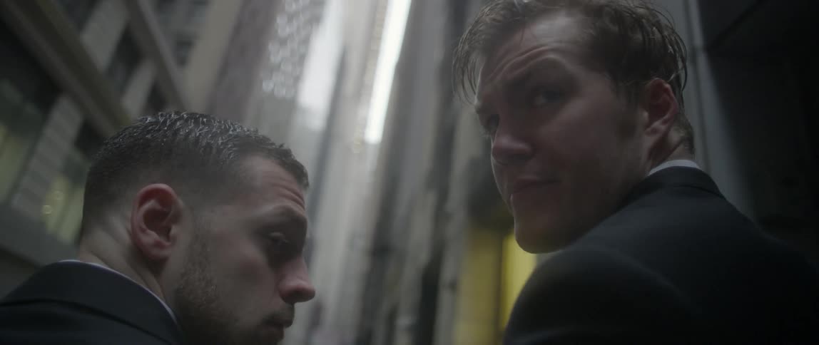 Two men look back over their shoulder