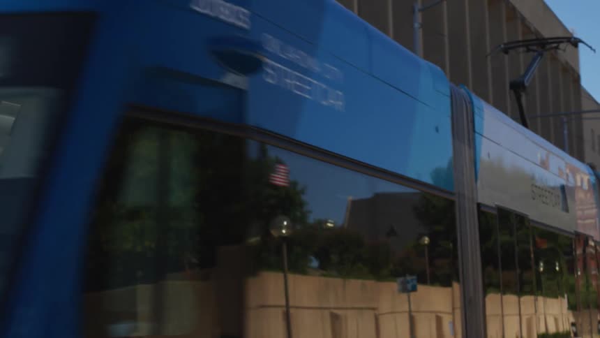 A bus drives down a city street during the day