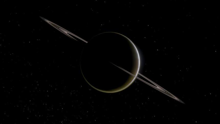 Saturn and its rings are backlit in outer space