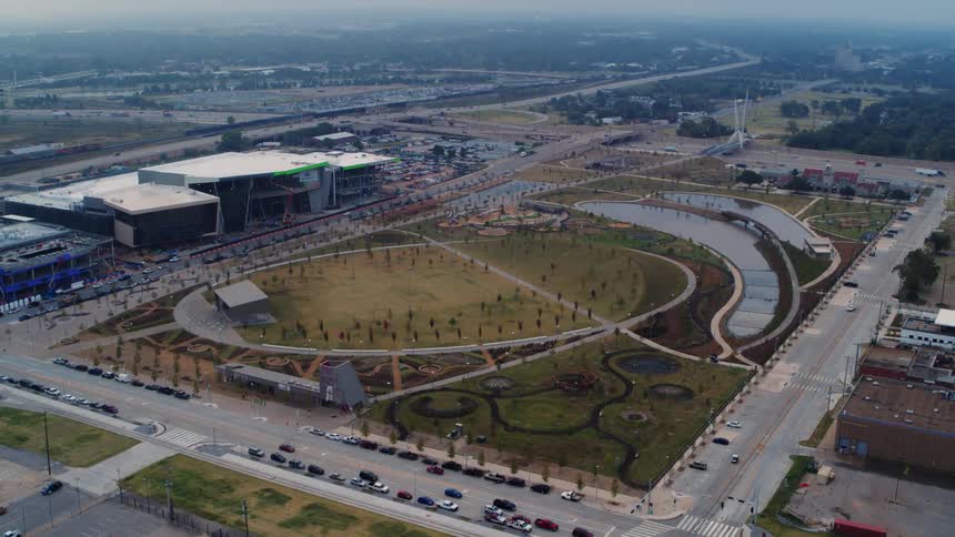 An aerial of an event center with a large oval concert yard