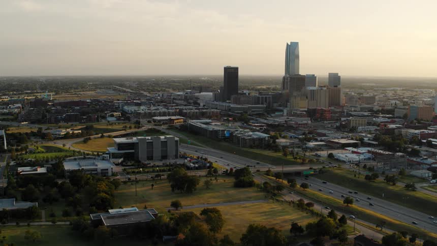 Aerial view of a downtown city at dusk is displayed