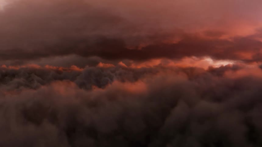 The sky is filled with layers of dark pink clouds as lighting is flashing throughout the atmosphere