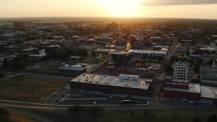An aerial view of buildings in a city at sunrise