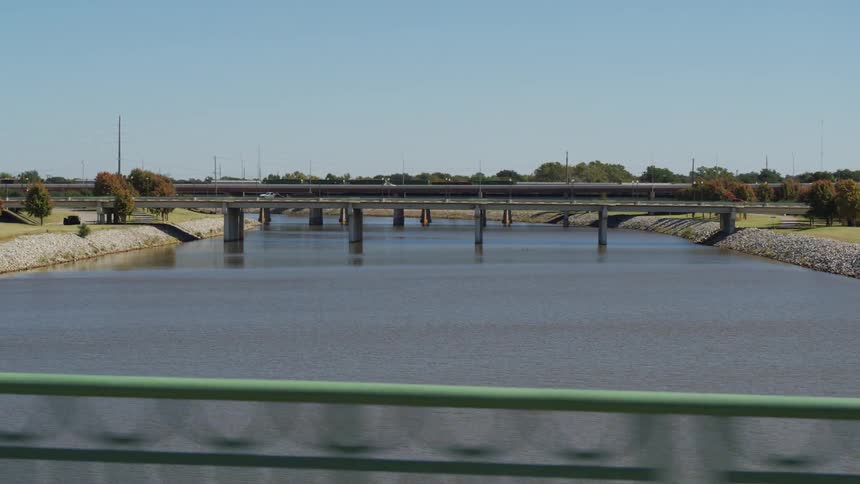 Cars driving across a bridge over a river