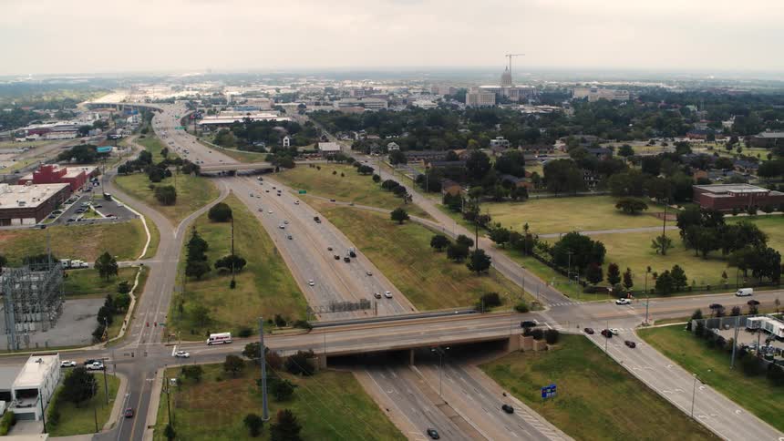Aerial view of cars driving on a highway is displayed