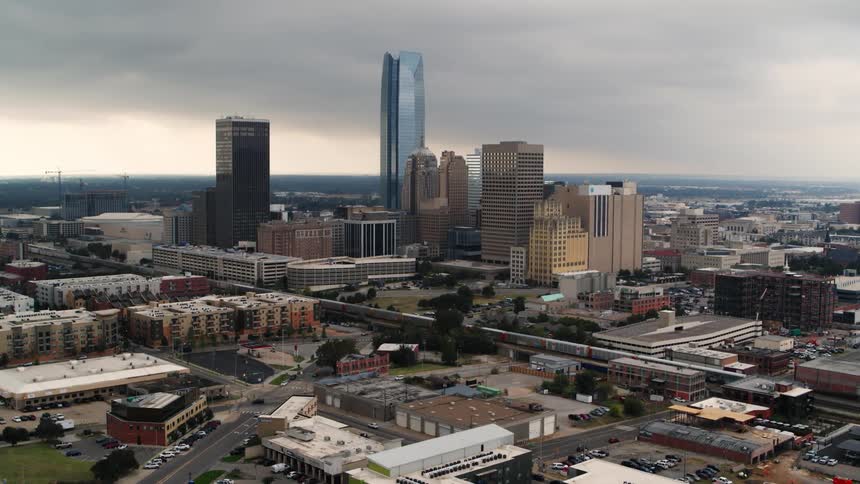 An aerial view of buildings and tall skyscrapers in a city