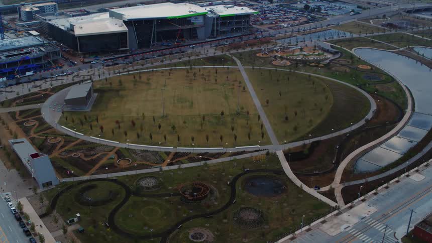 A park with cars in the background