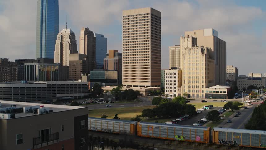 Cars are driving through a downtown city