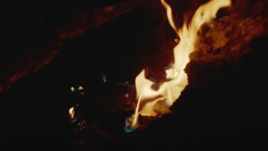 An up close of a small fire on rocks