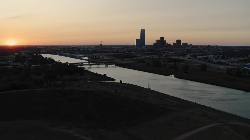 Aerial view of a city while the sun is setting is displayed