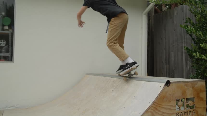 Child skateboarding on a small halfpike