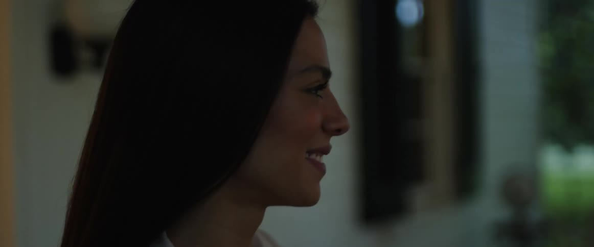 A close up of a womans face smiling and then walking away