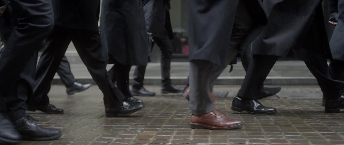 A group of people walking down a brick path