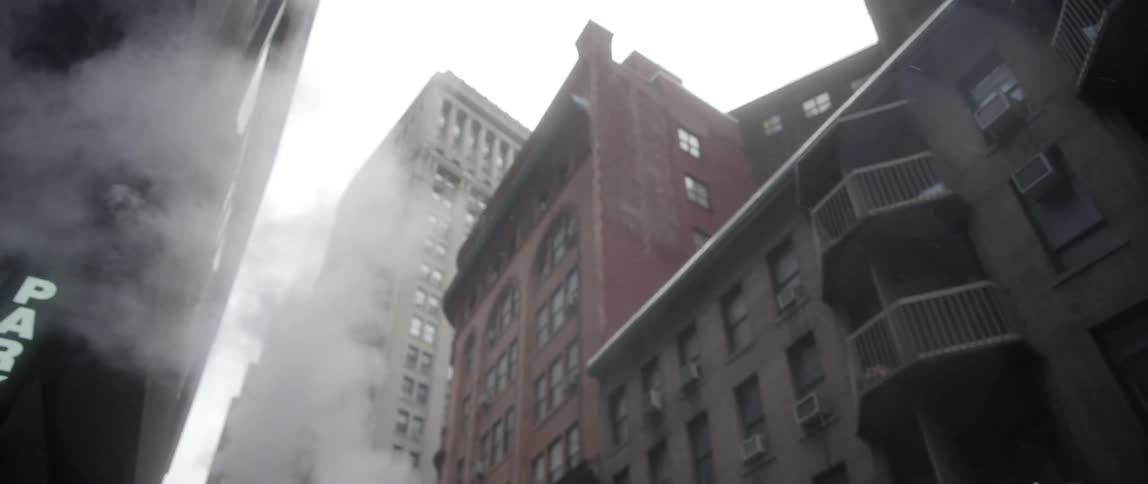 Steam rises in front of these tall buildings