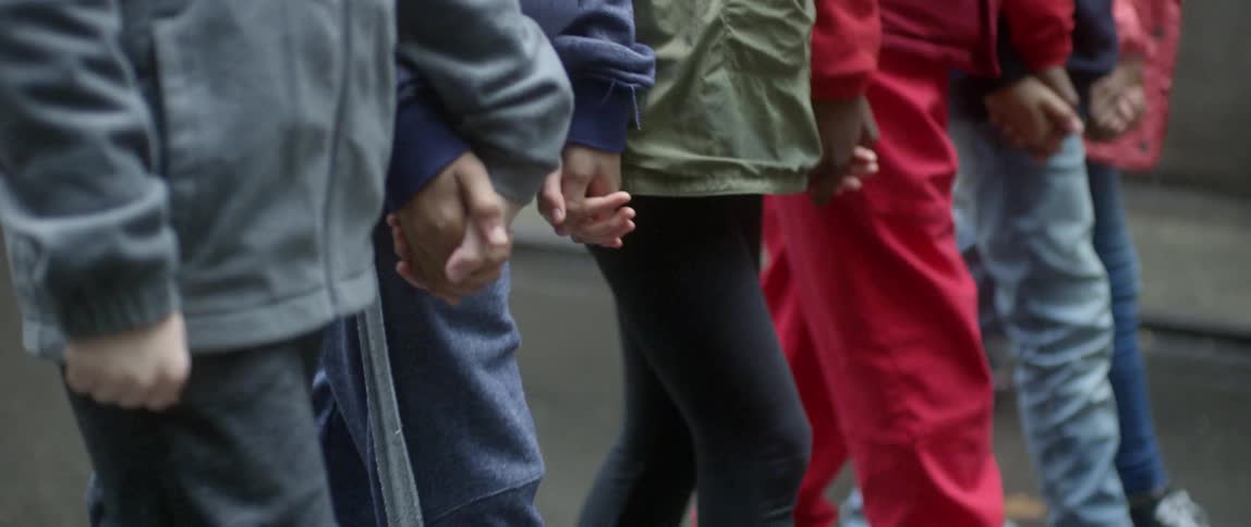 People are holding hands together and walking backwards