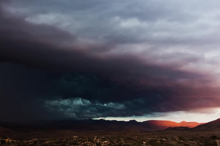 Dark storm clouds forming over a landscape in nature