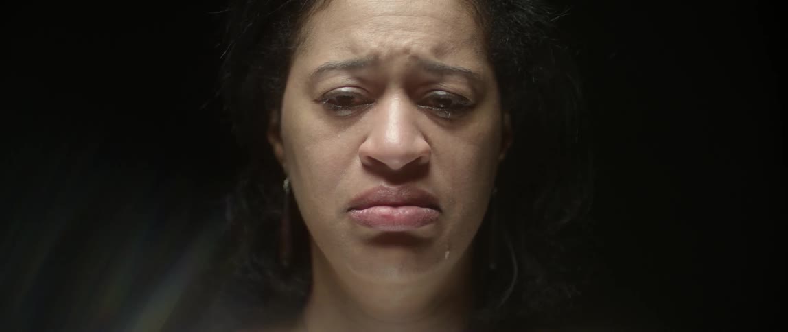 A woman looks sad and begins crying