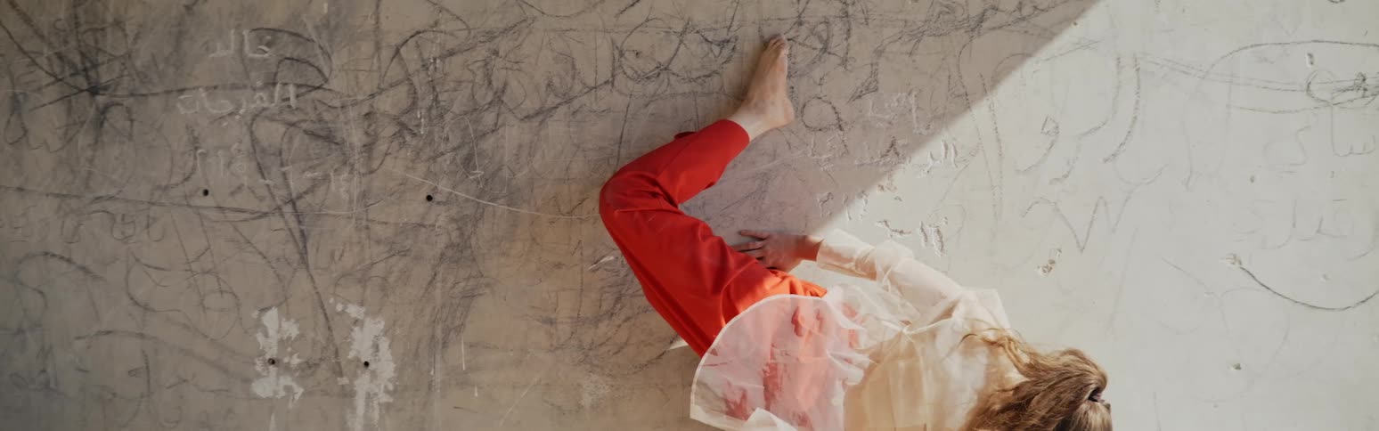 A nervous woman lies on cements and moves around