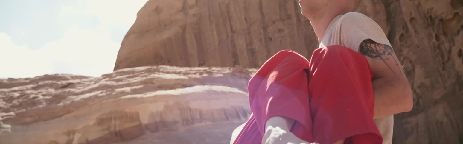 Man and woman stranded in desert woman collapses and man lifts her and carries her to safety