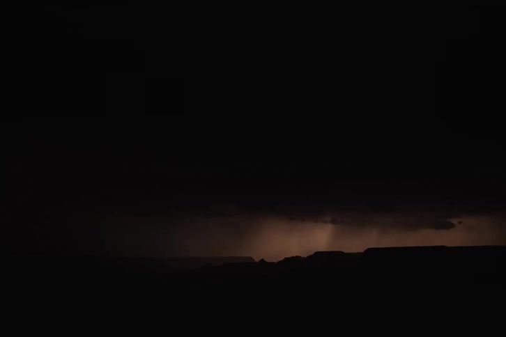 A distant lightning storm over the Grand Canyon