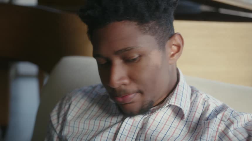 A man is drinking a cup of water indoors