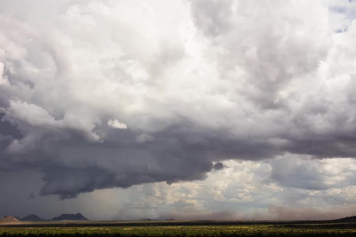 A supercell and wall cloud moving across the desert
