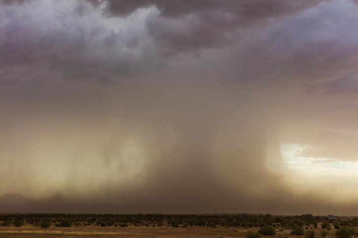 A wide strong monsoon downburst/microburst over the desert with blowing dust