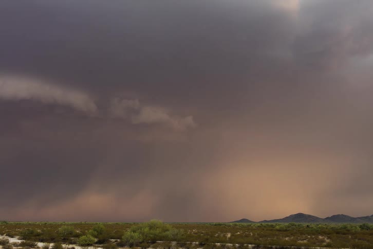 A storm forming in the distance of a desert plain landscape