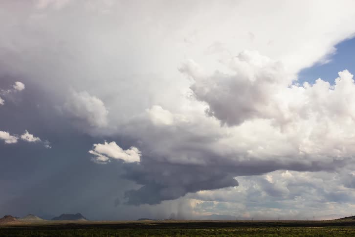 A rare supercell in Arizona spins up dust below it across the desert