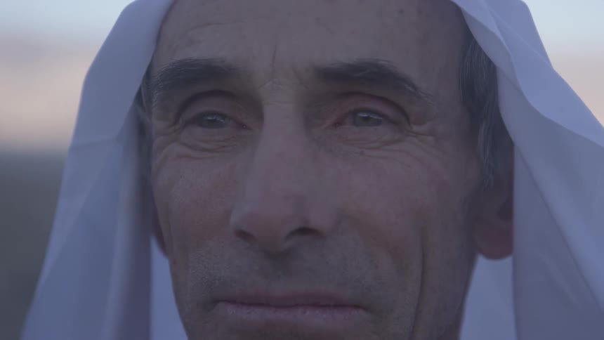 A man wearing a headpiece looks around