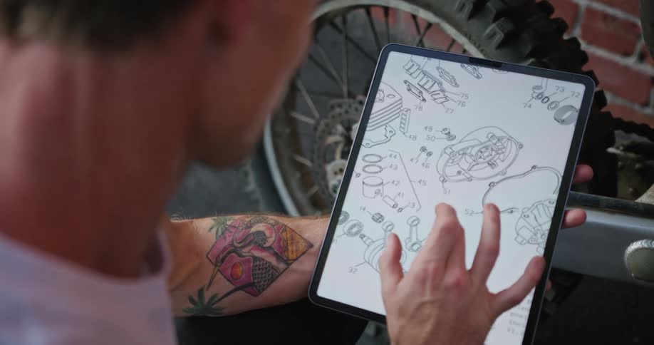A man is looking at a diagram on his tablet
