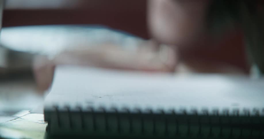 Father and daughter write down in notebook
