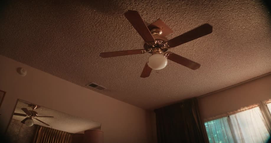 Red and blue lights rotate through room at night coloring the ceiling