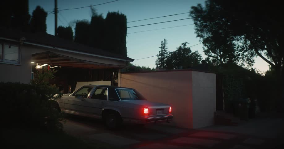 A man gets out of his car and runs inside