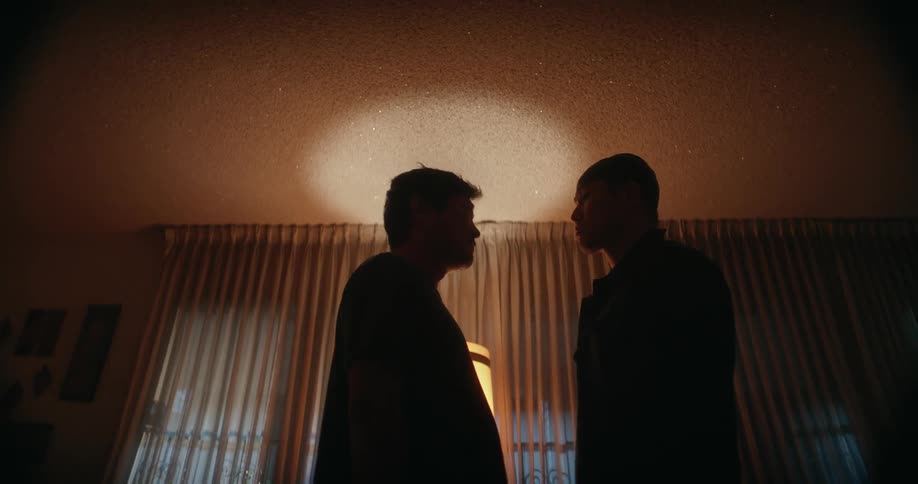 Two men stand face to face
