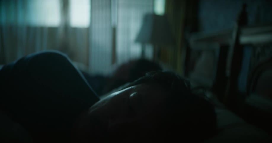 A male is sleeping in his bedroom next to someone