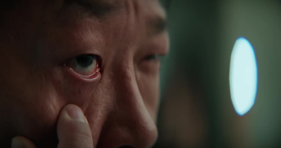 A man puts his finger under his eye and pulls down the skin