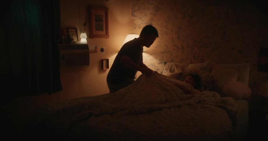 A father tucks in his daughter