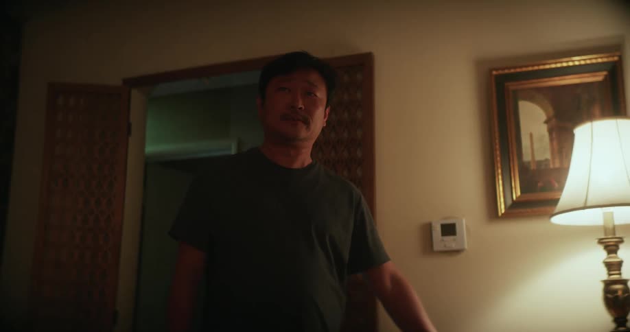 Man slowly enters room becoming more upset the further he walks