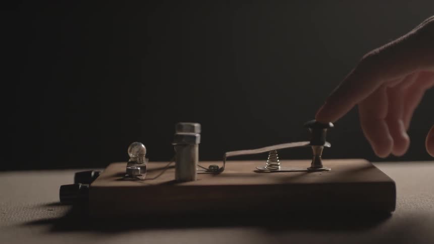 Person tapping on a morse code device