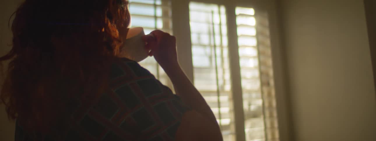 A woman drinking tea in a house
