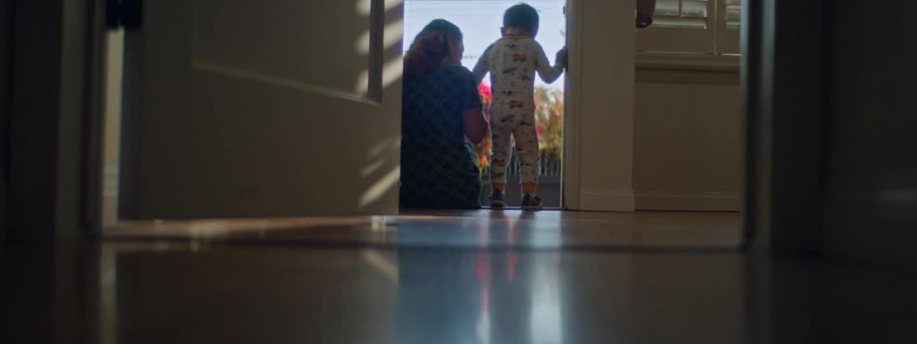Son walks up to mother sitting on the doorstep