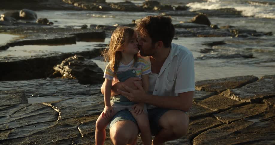 A father and daughter sitting around together