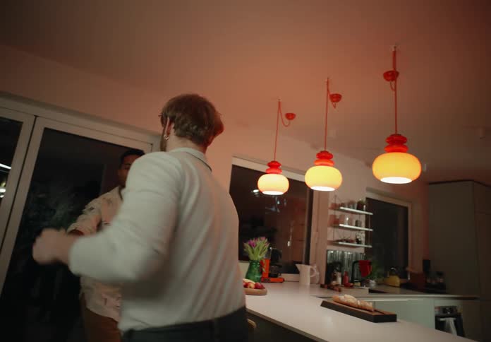 Same sex couple dances in their kitchen