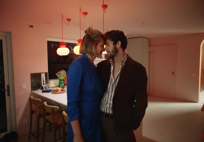 A man and woman standing in a room together