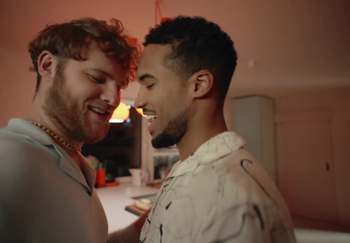 Gay couple dances and hold each other looking into each others eyes lovingly
