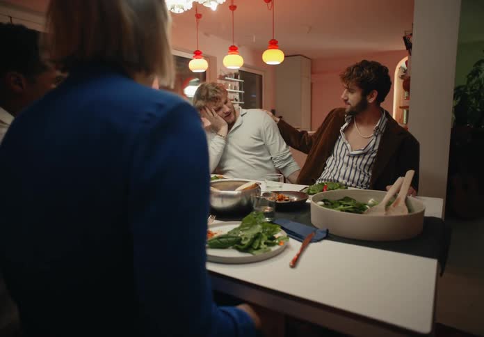 Gay couple having a dinner with friends